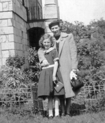 523: Mary (Ryan) Carroll and young Mary Carroll, by the Colonial Building in St. John's.  (circa 1937) [courtesy of Della (Norman) O'Leary]  - Mary daughter of David Ryan and Isabella Webber, married John Carroll; Mary  daughter of John Carroll and Agnes Rose